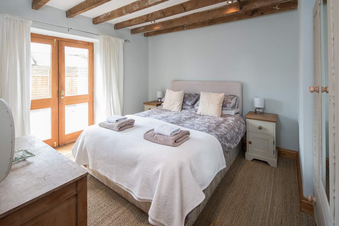 Bedroom 2 is a beautiful light and airy bedroom which leads out onto an enclosed courtyard and is home to a rather inviting king-size bed.