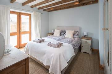 Bedroom 2 is a beautiful light and airy bedroom which leads out onto an enclosed courtyard and is home to a rather inviting king-size bed.