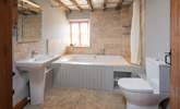 The en suite to the master bedroom boasts this fabulous double bath. Perfect for relaxing in after a hard day of fun and games. - Thumbnail Image