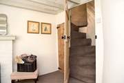 A doorway in the snug opens up to reveal the spiral staircase leading to Bedroom 2. 
Please note the stairs are steeper owing to the age of the cottage.