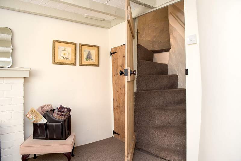 A doorway in the snug opens up to reveal the spiral staircase leading to Bedroom 2. 
Please note the stairs are steeper owing to the age of the cottage.