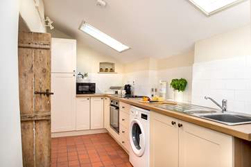 The galley kitchen sits at the back of the cottage.
