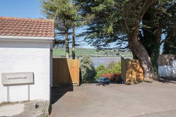 Parking for Cliff Top Cottage is in the white garage to the left of the picture.
