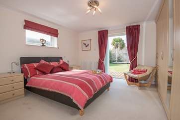 The master bedroom with doors leading to the pretty garden