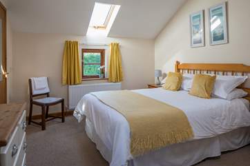 The light and airy main bedroom is super inviting.