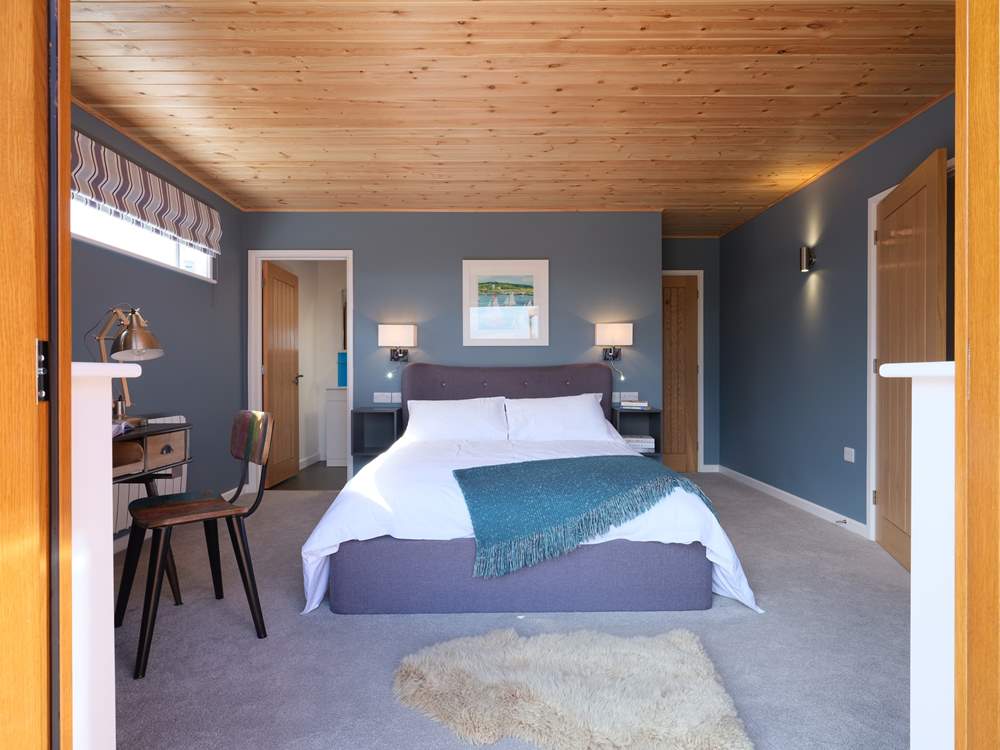 Looking from the deck into the master bedroom with the doors folded back.