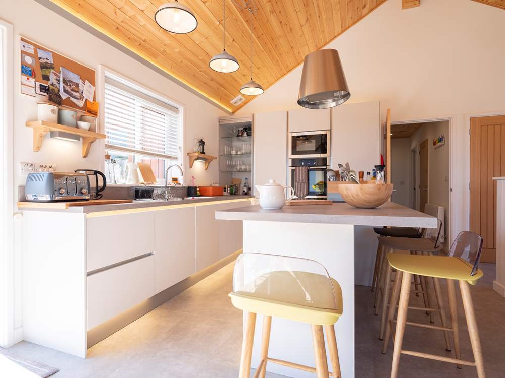 Sit and chat at the breakfast-bar while meals are prepared.