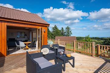 Two sets of bi-fold doors open out to the enclosed deck.