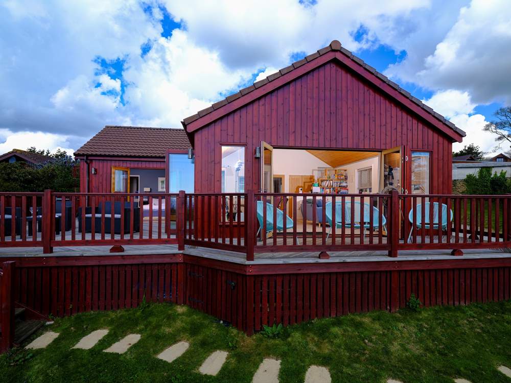 Two sets of bi-fold doors open out to the enclosed deck.