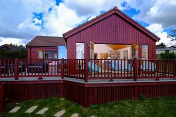 Two sets of bi-fold doors open out to the enclosed deck.
