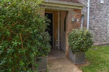The main entrance, tucked away to the side of the garage.