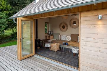 The beautiful cabin nestled in the garden provides the perfect spot to cuddle up and enjoy the view.