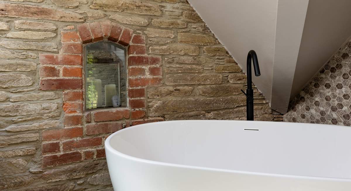 En suite to bedroom 3 boasts this beautiful free standing bath and eye-catching brickwork.