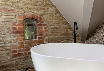 En suite to bedroom 3 boasts this beautiful free standing bath and eye-catching brickwork.