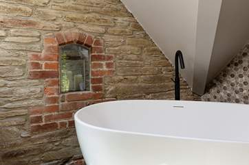 En suite to bedroom 3 boasts this beautiful free standing bath and eye-catching brickwork.