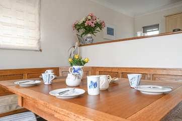 The dining-table has built-in banquette seating.