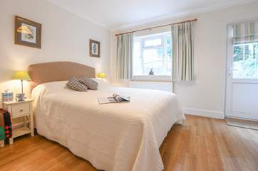 The second double bedroom with a door out to the rear patio.