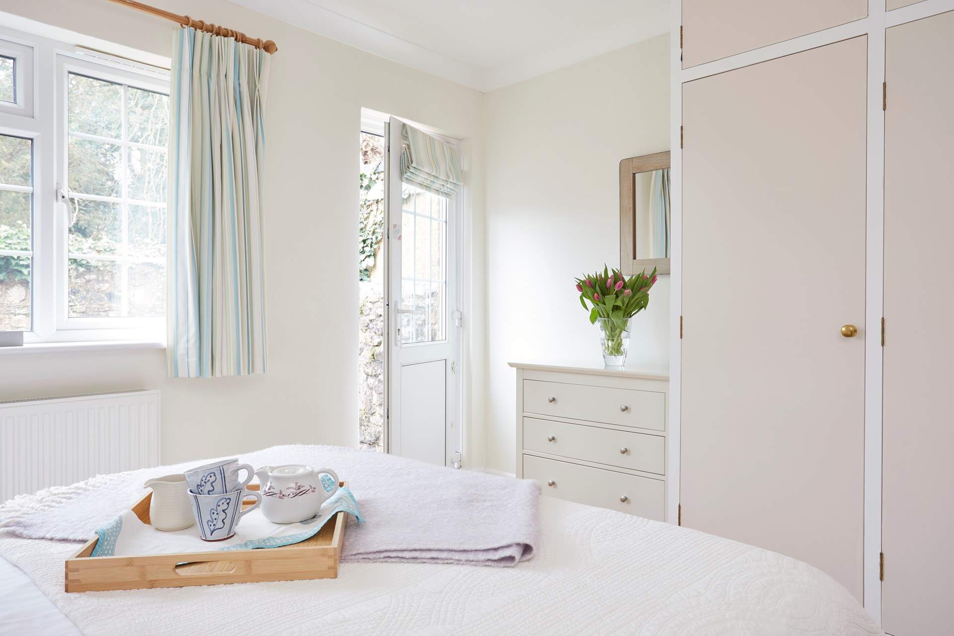 Bedroom 2 has a comfy king-size bed and access to the rear patio.