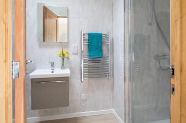 The en suite for bedroom 1 with under-floor heating and a large shower cubicle.