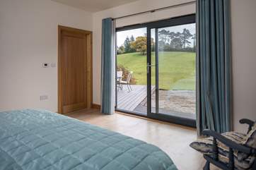 Bedroom 1 has lovely views across the valley and patio doors that open out onto the deck.