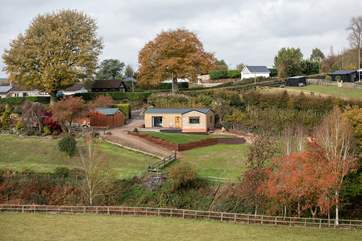 Cider Barn nestles into the hillside, the owner's home is to the left of the barn. Landscaping will include fencing to keep little ones and dogs safe.