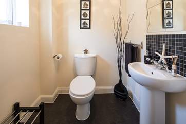 The downstairs WC offers a great space to store boots, shoes and flip flops alike, along with hanging space for your coats.