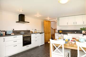 Everyone can gather for holiday meals in the modern kitchen/dining-room.