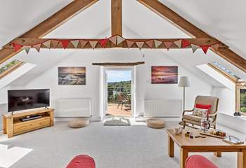 The light and airy sitting-room opens out to the balcony and that fabulous view.