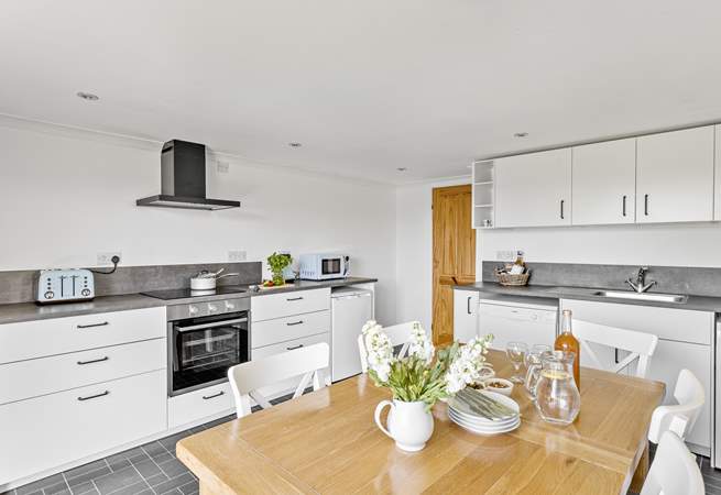 Everyone can gather for holiday meals in the modern kitchen/dining-room.