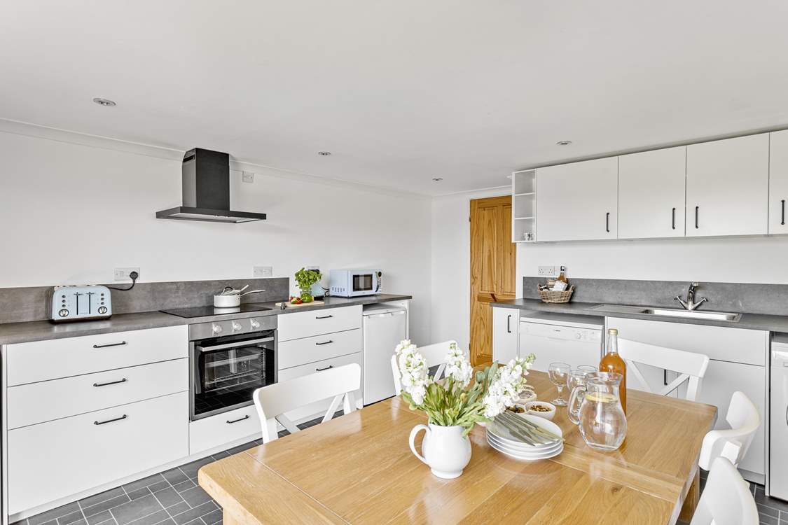 Everyone can gather for holiday meals in the modern kitchen/dining-room.