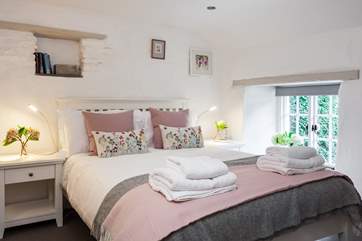 The super comfy double bedroom overlooks the pretty garden.