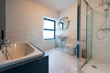 The bathroom is fab and wonderfully spacious with beautiful tiles, a double ended bath and large shower.