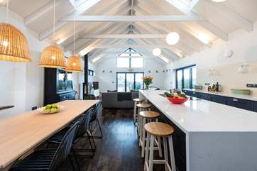 The island provides oodles of space when preparing meals and provides a natural divide between the dining-area and kitchen.