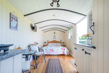 The interior is light, bright and surprisingly spacious. There is even a kitchen-area, with a single induction hob and all-important kettle.