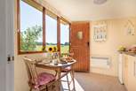 The separate cabin houses a well-equipped kitchen-area, en suite shower-room and a pretty little table and chairs for eating with a view.