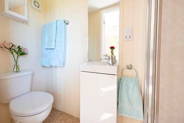 The shower-room is complete with electric hot shower and proper flushing loo.