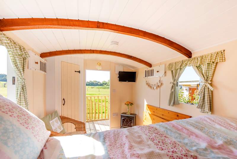 There's a comfortable double bed, country-style furnishings and a small TV but you'll probably want to gaze out over the meadow and fields beyond.