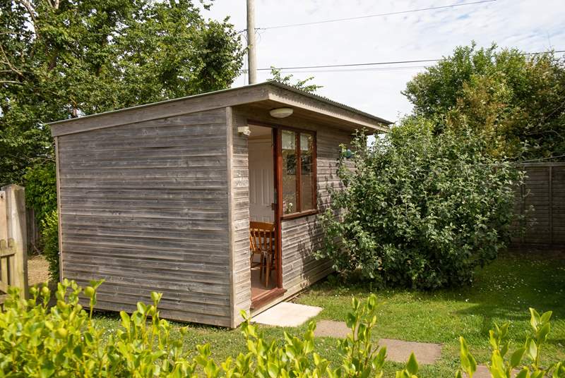 Just a few steps away is this purpose built cabin, complete with kitchen, dining area and shower-room.