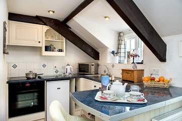 The kitchen has all that a couple will need for a break here.