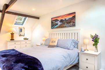 The bedroom has a cheerful beachside theme