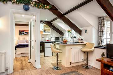 This spacious room houses the kitchen, dining and living areas.