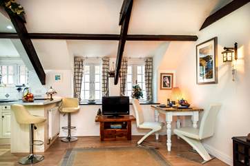 There is a breakfast-bar to one side and a dining-table to the other.