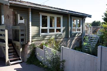 Steps leading you up to the entrance and wooden verandah.
