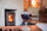 Glass of wine and a roaring fire - The House of Logs is perfect all year around