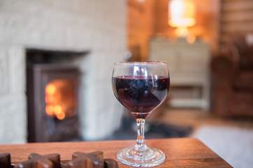 Glass of wine and a roaring fire - The House of Logs is perfect all year around
