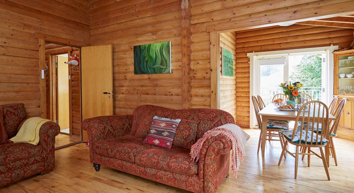 The open plan living and dining area with doors leading out onto the balcony.