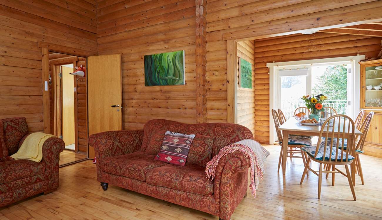 The open plan living and dining area with doors leading out onto the balcony.