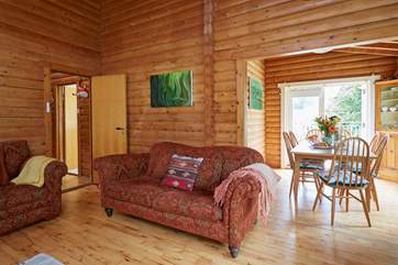 The open plan living and dining area with doors leading out onto the balcony.