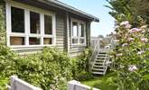 Welcome to House of Logs, a truly unique property just a short walk from Totland Bay. Steps lead up to the balcony from the garden. - Thumbnail Image