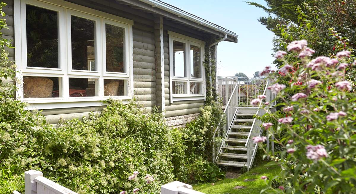 Welcome to House of Logs, a truly unique property just a short walk from Totland Bay. Steps lead up to the balcony from the garden.